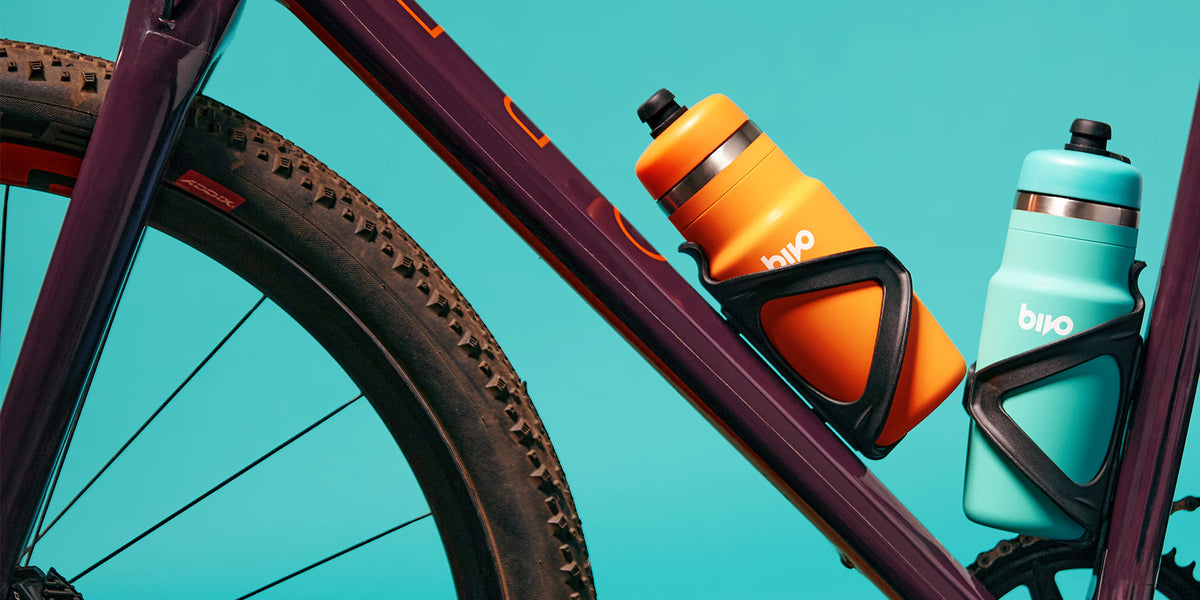 Bivo One stainless steel performance cycling bottle in bike cage with tactile exterior to reduce noise and create exceptional grip. Clean taste. High flow. Dishwasher safe.